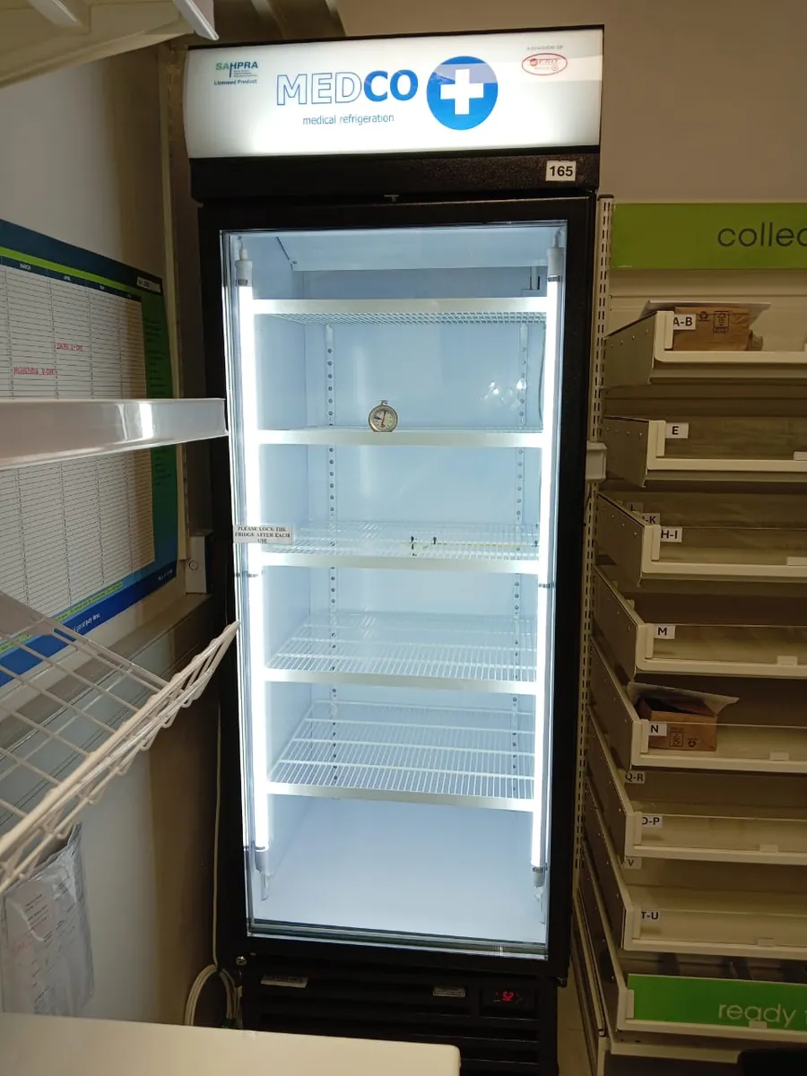 Upright glass-door display fridge in a pharmacy